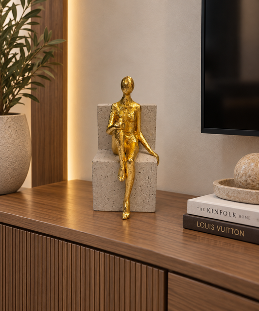Gold Figurine on Concrete Base