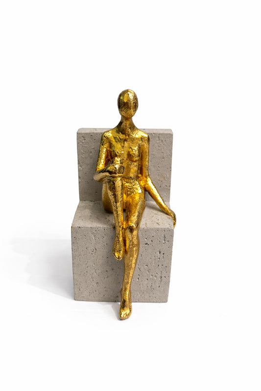 Gold Figurine on Concrete Base